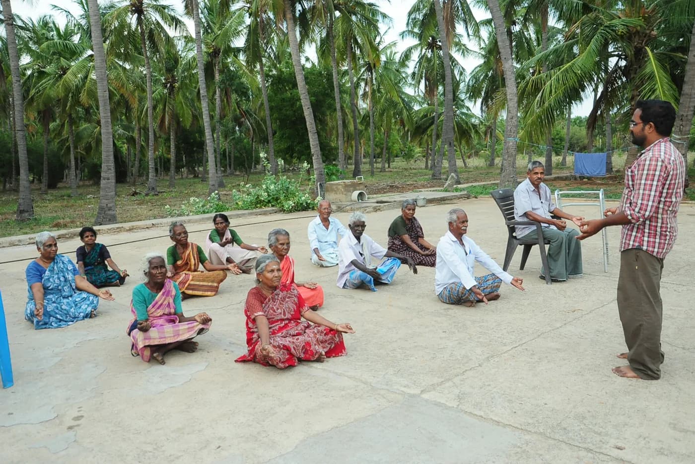 A community meeting organised by READ under the trees